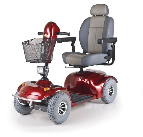 A red four-wheeled electric mobility scooter with a basket and bucket seat.