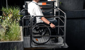 A person in a wheelchair using a vertical lift