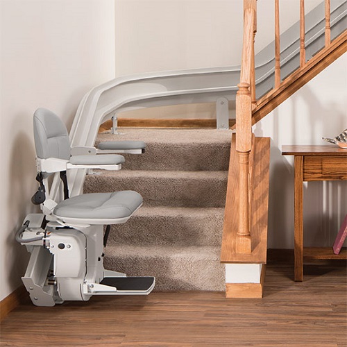 A stair lift installed on a L-shaped staircase.