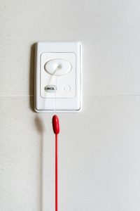 Bed alarm mounted to a wall 