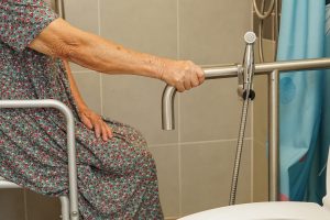 Older adult using a grab bar for stability